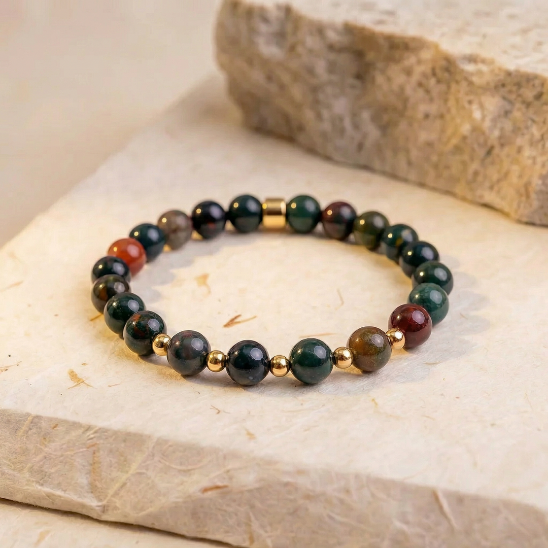 Beaded bracelet with gold accents on a stone surface