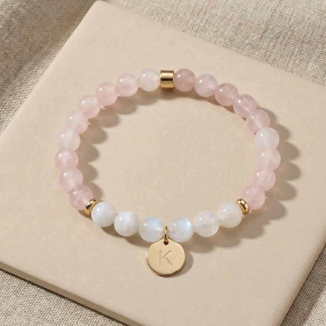 Beaded bracelet with a gold charm on a beige surface